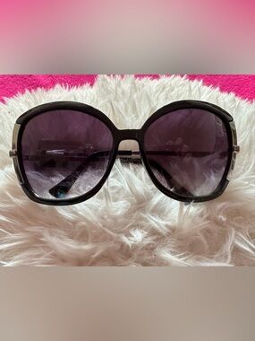 Jennifer Lopez Women’s Black Frame Sunglasses with Purple Tinted Lenses